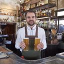 Bartender with local beer at the Public House in Hotel Palisade, Millers Point.