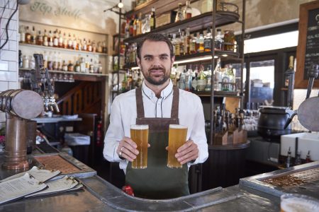 Bartender with local beer at the Public House in Hotel Palisade, Millers Point.