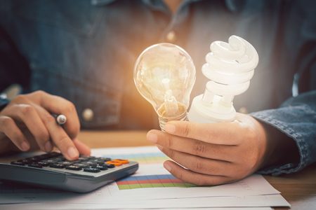 The Hand Was Holding An Incandescent Light Bulb And A Spiral Lig