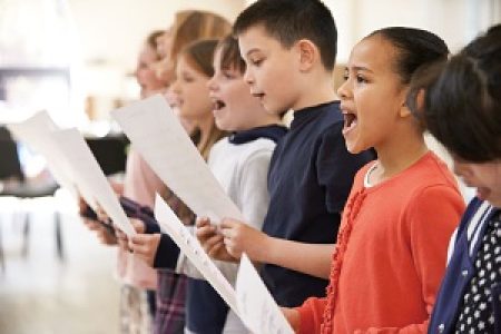 Group Of School Children Singing In Choir Together